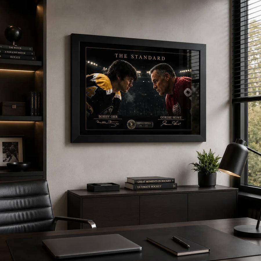 Black-framed Bobby Orr vs Gordie Howe hockey wall art mounted in a modern executive office beside a window.