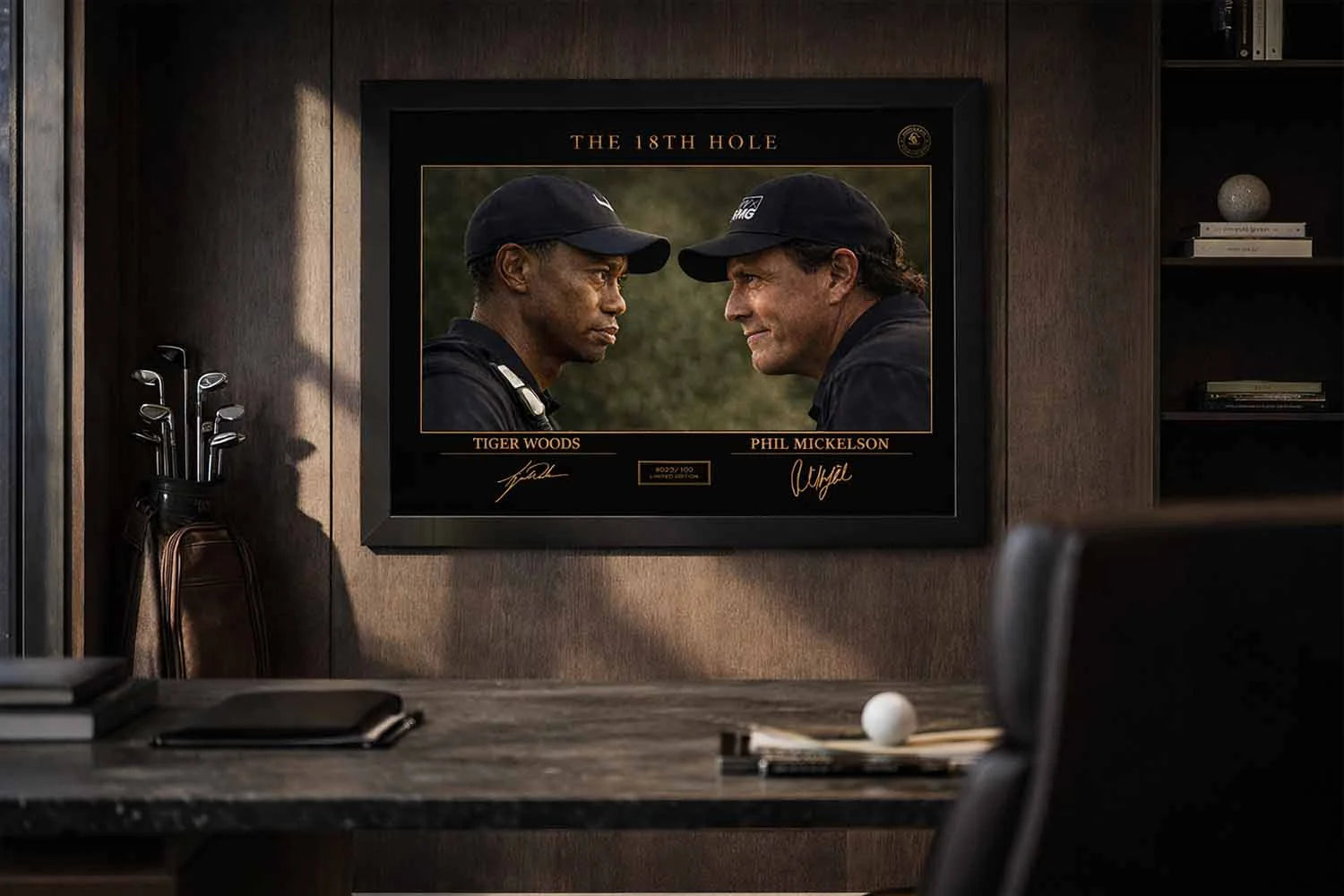 Tiger Woods vs Phil Mickelson framed sports memorabilia showcased in a luxury office with warm lighting and golf décor