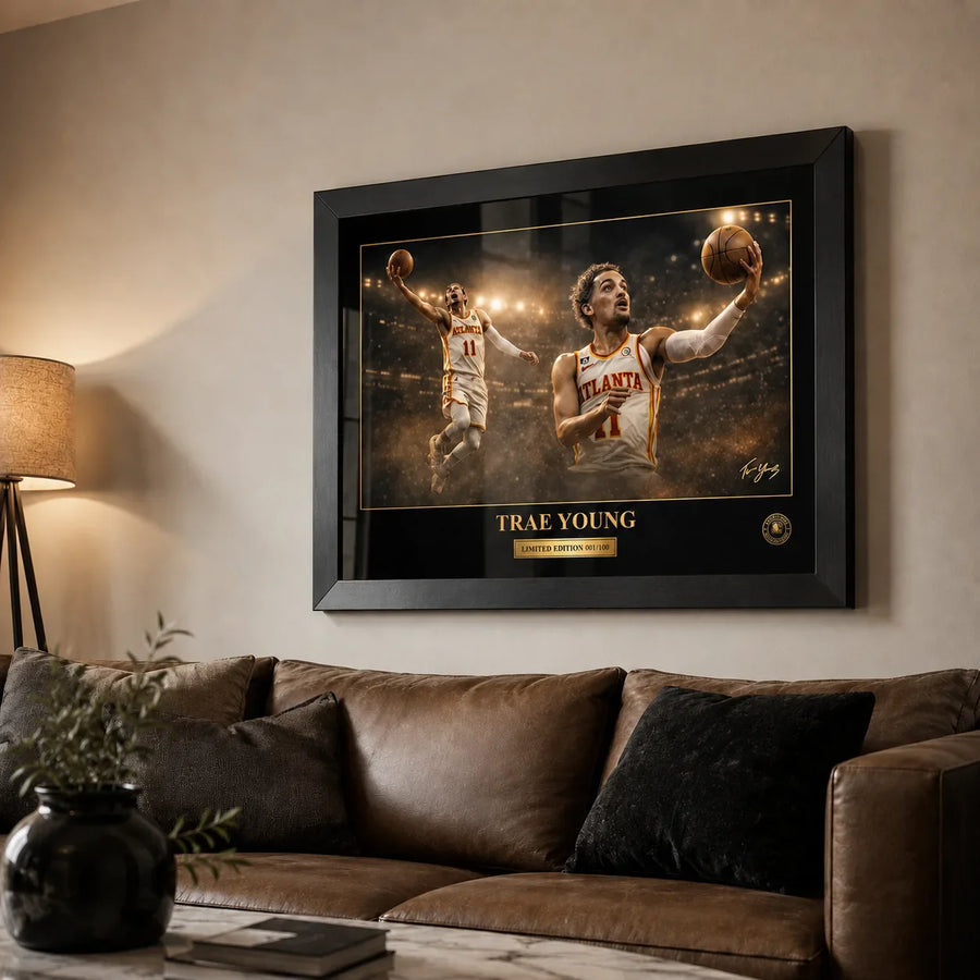Trae Young framed NBA wall art above a brown leather sofa in a warm living room with soft lamp lighting.