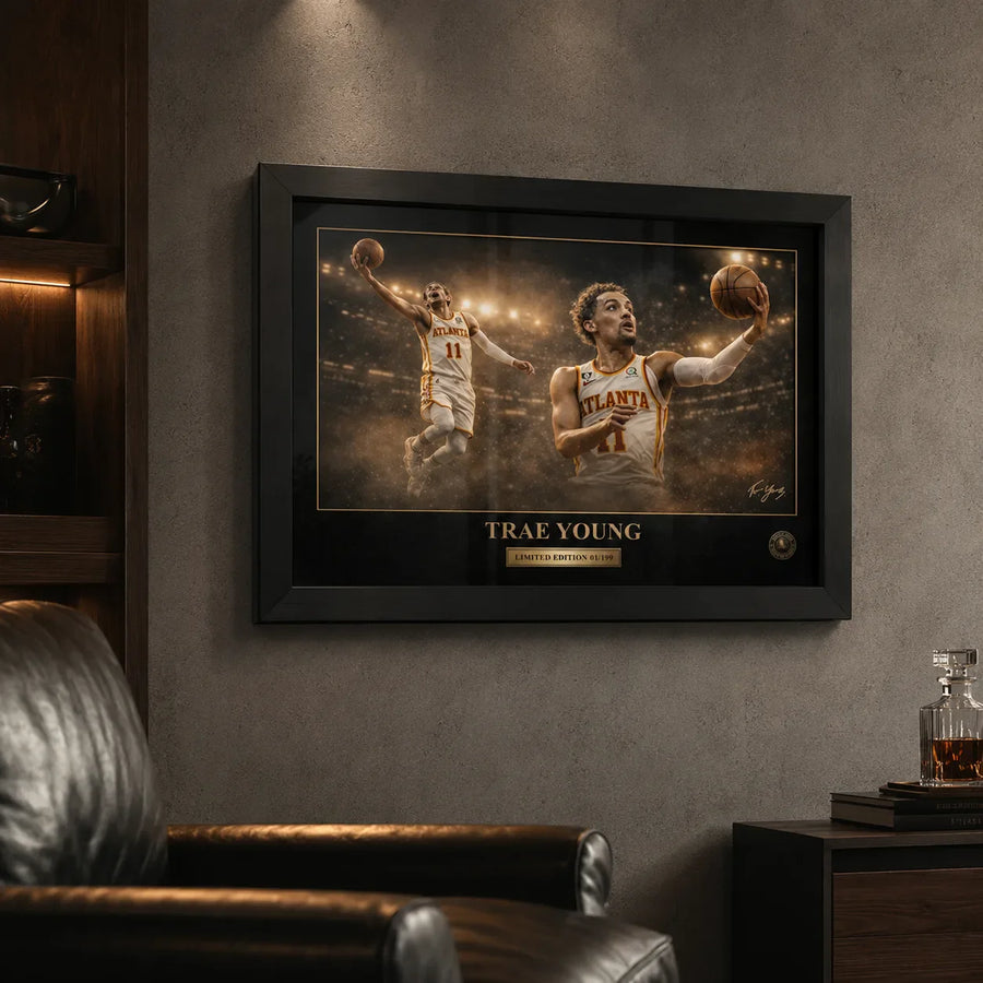 Trae Young framed NBA wall art on a textured grey wall in a dark man cave with timber shelving and bar details.