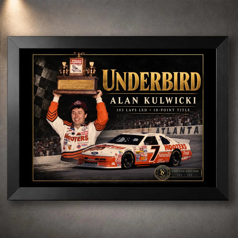 Black framed Alan Kulwicki Underbird NASCAR wall art featuring the championship trophy and orange number 7 race car.