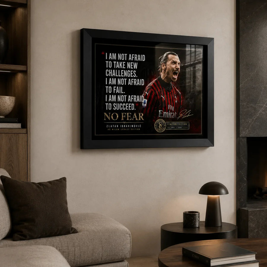 Zlatan Ibrahimovic soccer wall art in a black frame displayed above a sofa in a modern living room.