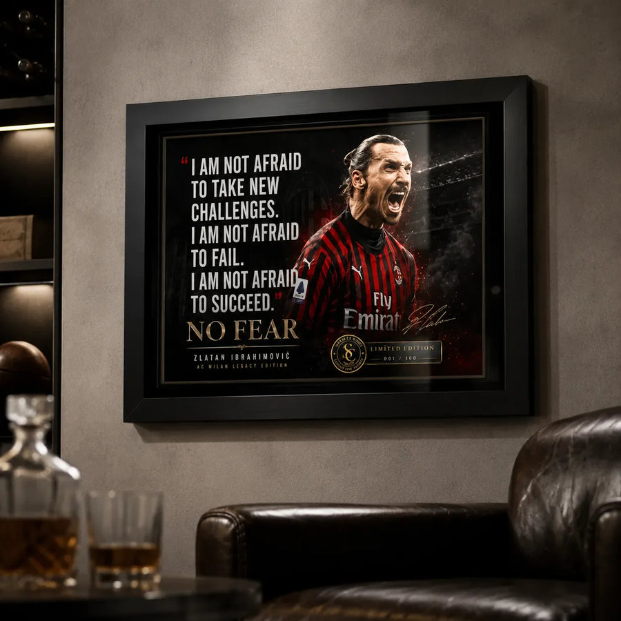 Black framed Zlatan Ibrahimovic soccer wall art displayed on a dark man cave wall above leather seating.