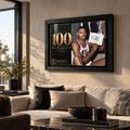Wilt Chamberlain wall art displayed above a light sofa in a modern living room, finished in a black frame.