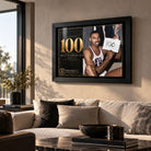 Wilt Chamberlain wall art displayed above a light sofa in a modern living room, finished in a black frame.