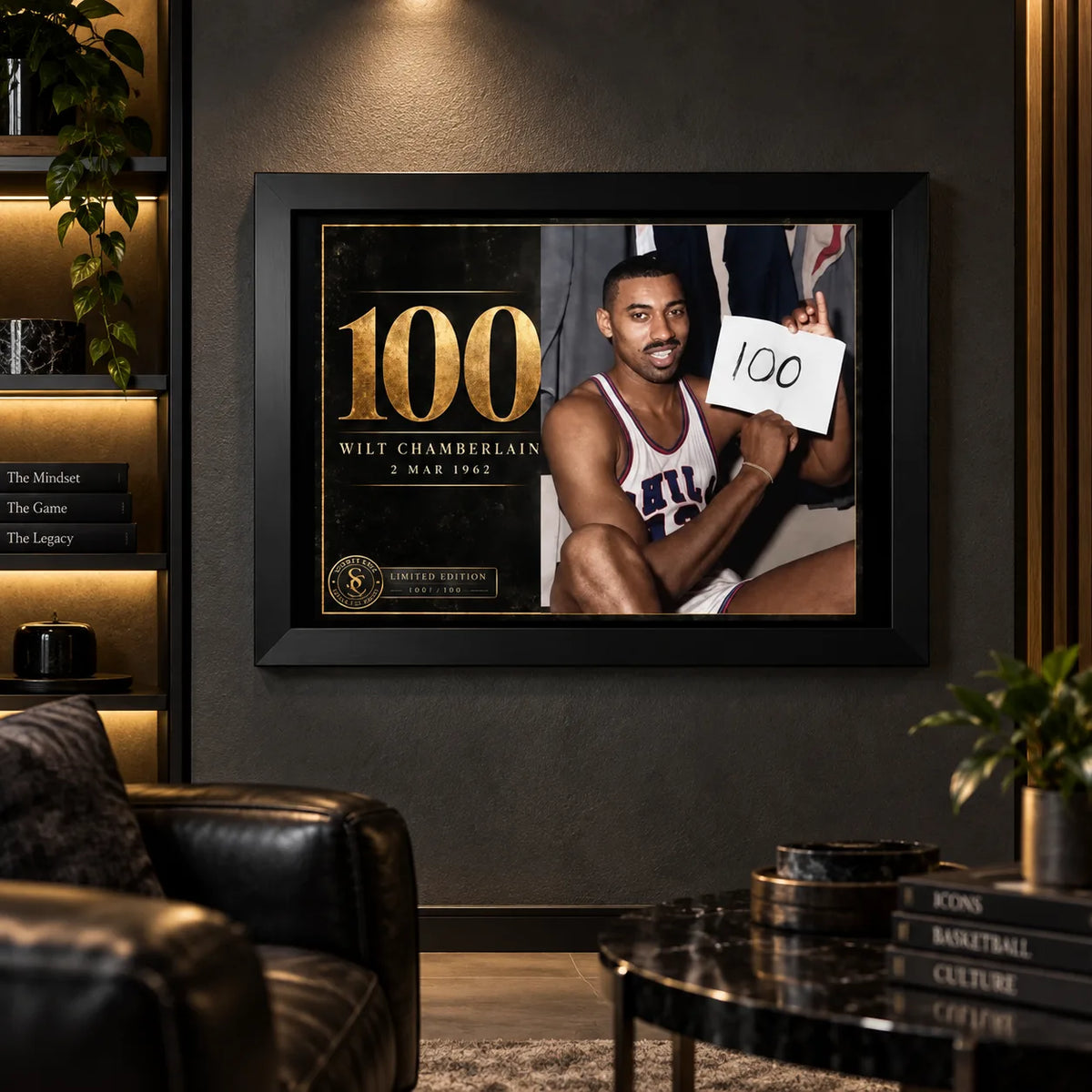 Wilt Chamberlain wall art displayed in a dark man cave setting with black framing and warm shelf lighting.