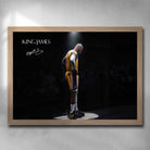 Oak framed King James art by Sports Cave, showcasing the legendary basketball icon spotlighted against a blurred audience background.