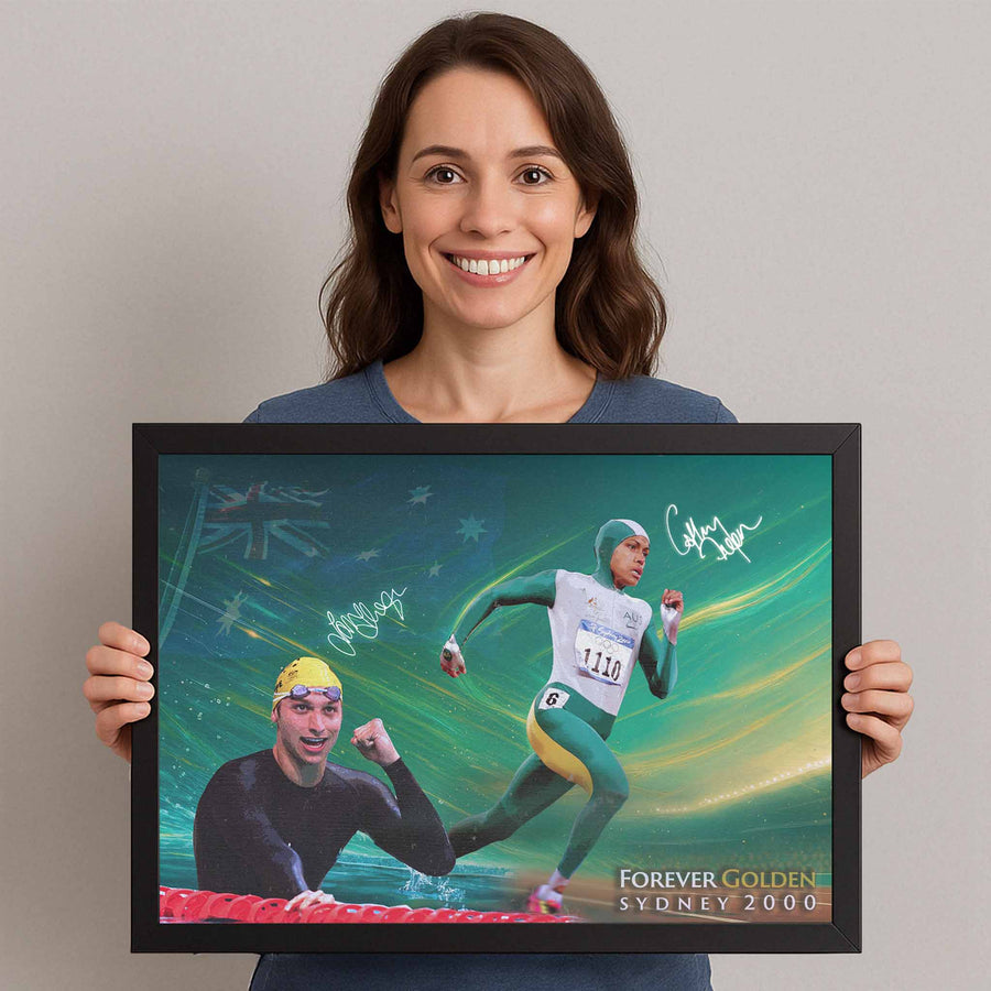 Woman holding framed sports art of Cathy Freeman and Ian Thorpe, a premium sports collectible from www.sportscaveshop.com.