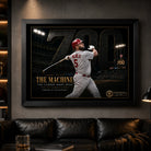 Black framed Albert Pujols 700 baseball wall art displayed in a dark premium man cave with focused lighting.