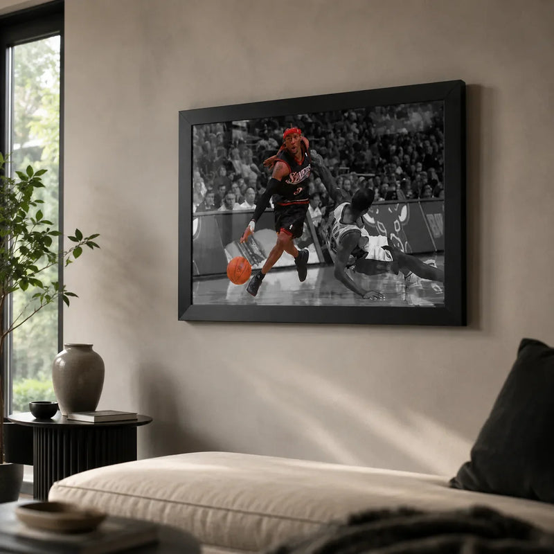 Allen Iverson crossover artwork in a black frame on a neutral living room wall above a light sofa.