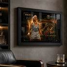 Black framed Ash Barty tennis wall art displayed in a dark man cave with shelves, leather chair and soft reflections.