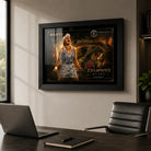 Black framed Ash Barty tennis wall art displayed in a premium office setting above a desk and black chair.
