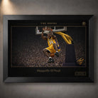 Black framed basketball wall art with gold collector details displayed on a textured grey wall