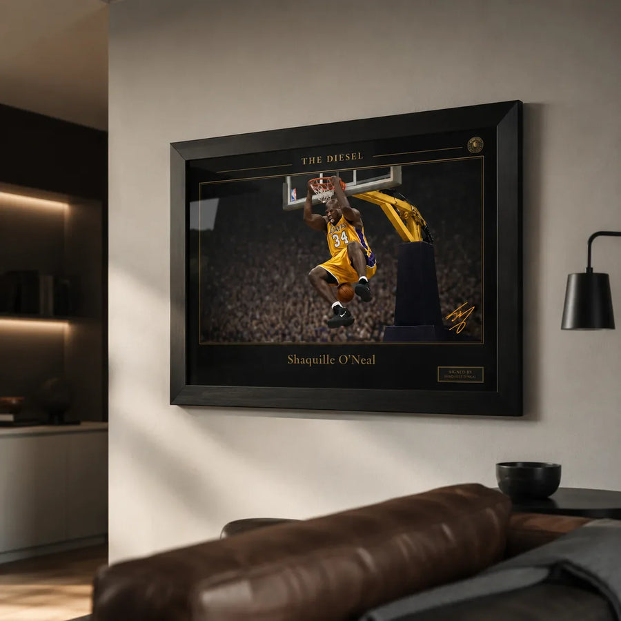 Black framed basketball wall art displayed on a warm modern living room wall above leather seating
