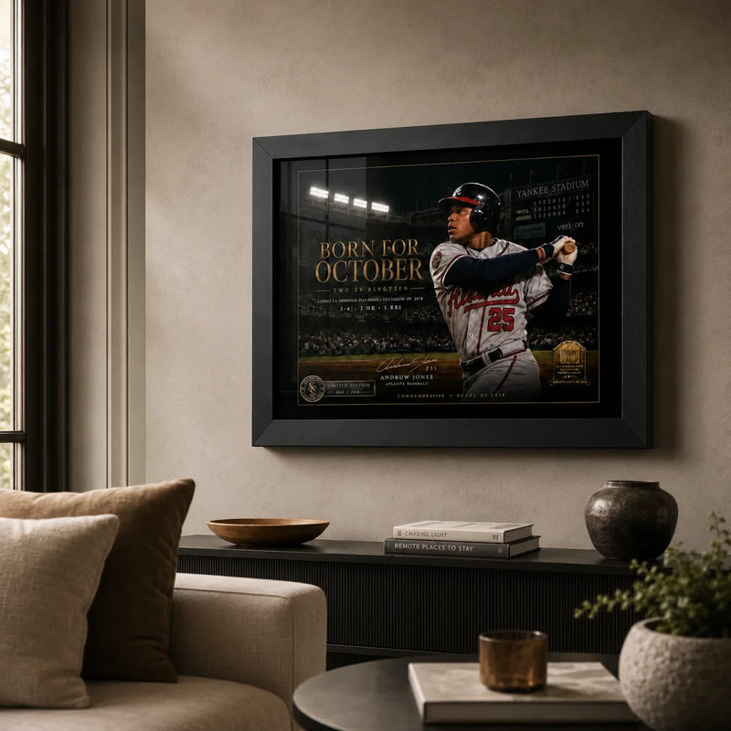 Born for October Andruw Jones wall art displayed in a warm living room above a low cabinet in a black frame.