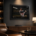 Black framed Andruw Jones baseball wall art displayed in a dark man cave with leather seating and warm lighting.
