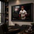 Black framed Bryce Harper baseball wall art displayed in a dark premium man cave with timber shelving.