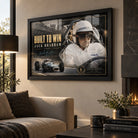 Black framed Jack Brabham Built To Win 1966 motorsport wall art displayed above a neutral sofa in a warm living room.