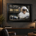 Jack Brabham Built To Win 1966 motorsport wall art in a black frame on a dark man cave wall above leather seating.
