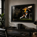 Caitlin Foord soccer wall art in a black frame displayed above a desk in a modern home office.