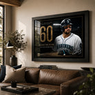 Cal Raleigh 60-homer wall art displayed above a leather sofa in a warm contemporary living room.