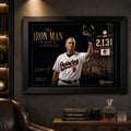 Black framed Cal Ripken Jr. baseball wall art displayed in a dark premium man cave with timber shelving.