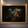 Oak framed Conor McGregor wall art featuring The Notorious beneath arena lights with both championship belts raised.