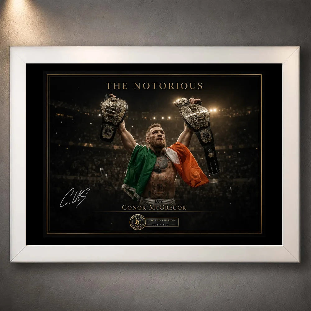 White framed Conor McGregor wall art featuring The Notorious with the Irish flag and both championship belts raised.
