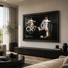 Black-framed Cristiano Ronaldo CR7 soccer wall art displayed above a dark console in a bright modern living room.