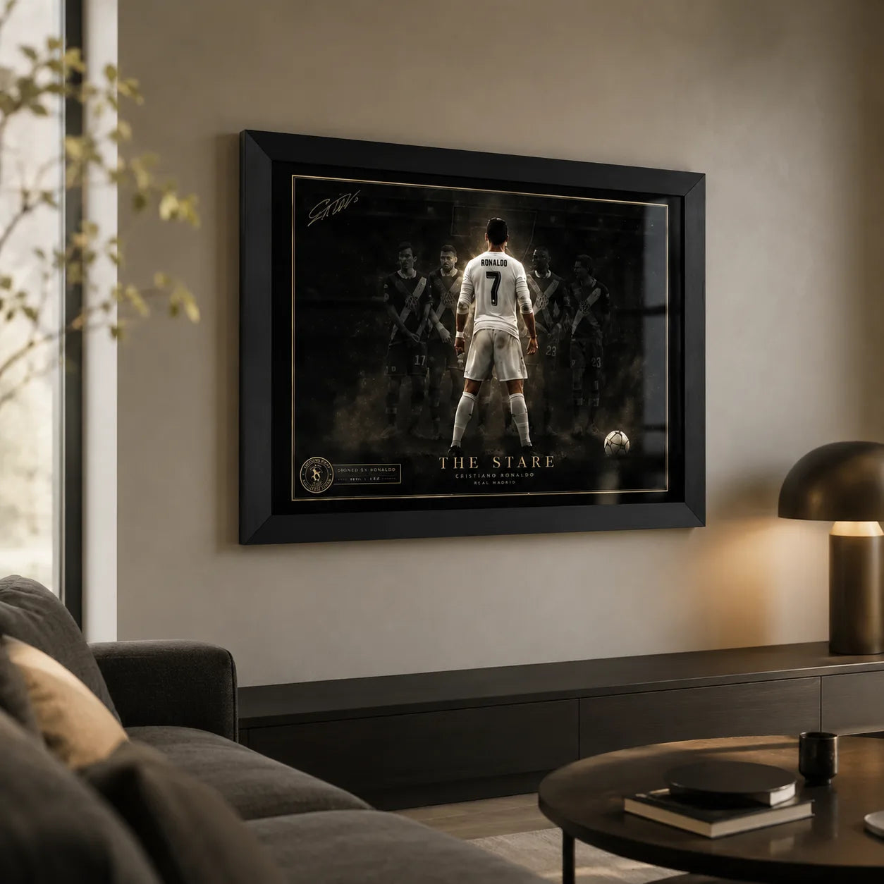 Black framed Cristiano Ronaldo soccer wall art displayed in a premium living room with soft lamp lighting