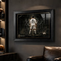 Cristiano Ronaldo football wall art in a black frame inside a dark man cave with leather chair and shelves