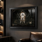Cristiano Ronaldo football wall art in a black frame inside a dark man cave with leather chair and shelves