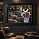 Casey Stoner wall art displayed in a dark motorsport man cave with the black framed Crowned at Home design.