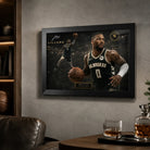 Damian Lillard Bucks framed wall art displayed in a dark sports lounge with shelves, leather chair, and warm ambient lighting.