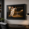 David Warner black framed sports art displayed above a refined office desk with soft cinematic lighting and neutral decor.