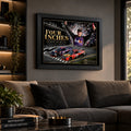 Denny Hamlin Daytona 500 racing artwork displayed above a charcoal sofa in a contemporary living room.