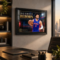 Cade Cunningham wall art displayed in a modern office setting with a black frame.