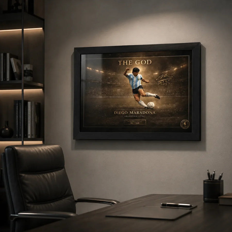 Diego Maradona framed soccer wall art displayed on an office wall above a desk with dark leather chair.