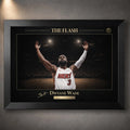 Black framed basketball wall art featuring gold detailing and dramatic arena lighting.