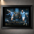Black framed Erling Haaland Manchester City wall art featuring two action poses and blue stadium graphics.