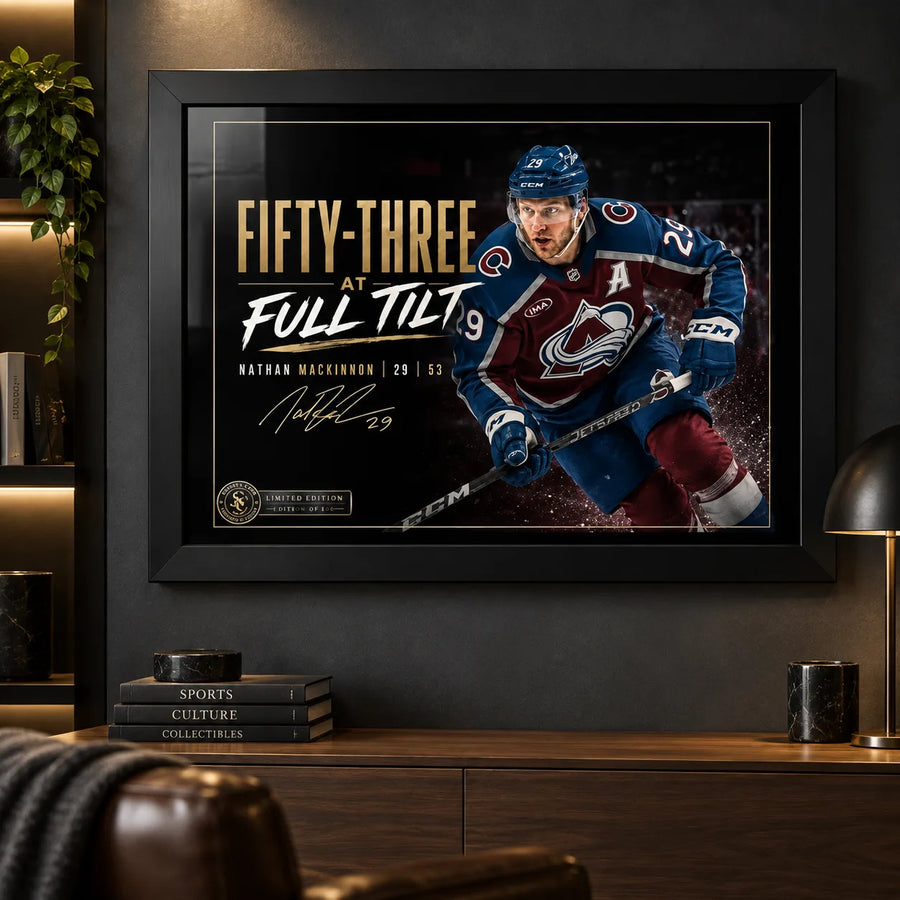 Nathan MacKinnon wall art in a dark man cave setting, black framed above a timber console with warm display lighting.