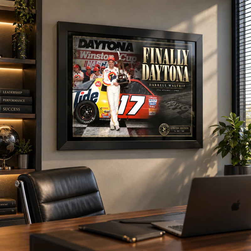 Darrell Waltrip NASCAR wall art displayed in a modern office above a timber desk with black leather seating.