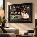Dale and Ned Jarrett Go Baby Go NASCAR wall art displayed in a bright living room with a black frame.