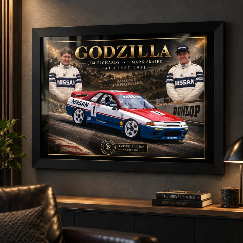 Jim Richards and Mark Skaife Godzilla wall art displayed in a dark motorsport man cave with a black frame.