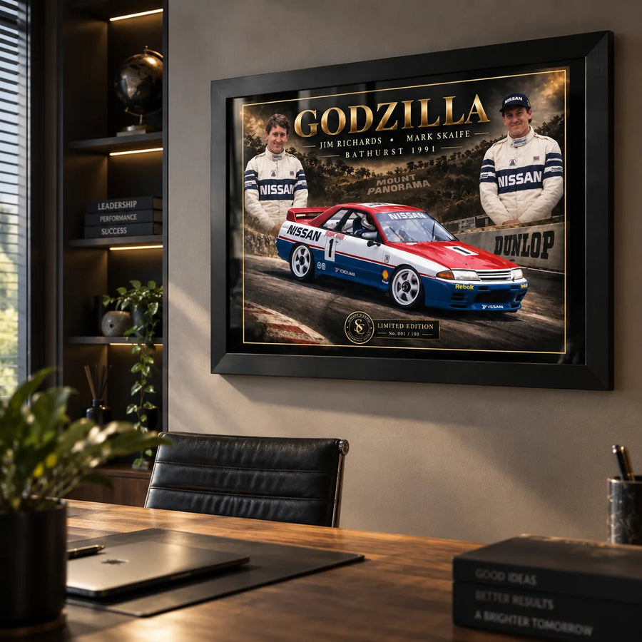 Jim Richards and Mark Skaife Godzilla wall art displayed in a modern office setting with a black frame.