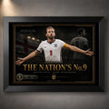 Harry Kane wall art in a black frame, showing The Nation’s No. 9 England football artwork on a dark stadium backdrop.