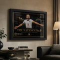 Harry Kane wall art in a black frame displayed on a warm neutral living room wall beside a lamp and sofa.