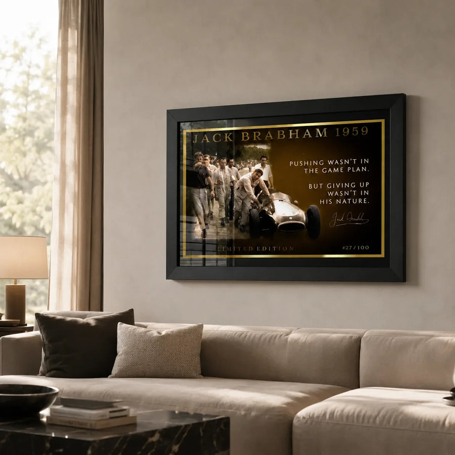 Jack Brabham motor racing wall art in a black frame displayed above a neutral living room sofa.