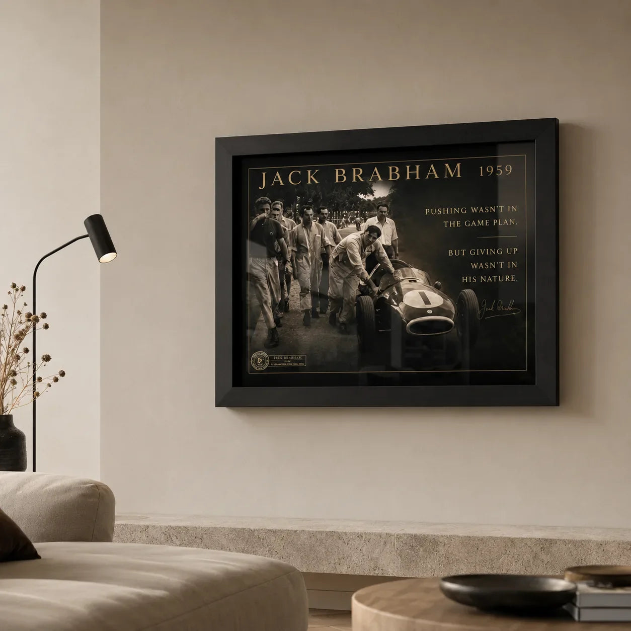 Black-framed Jack Brabham motorsport wall art displayed above a neutral sofa in a warm contemporary living room.
