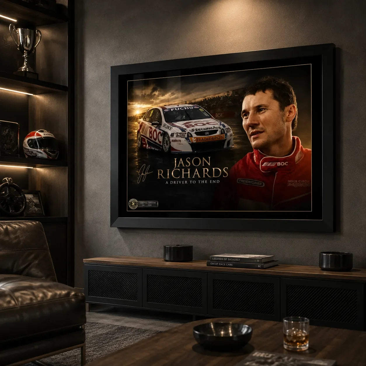 Black framed Jason Richards motorsport wall art displayed in a dark man cave with racing memorabilia and leather seating.